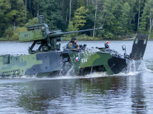 Soldiers from the 4th Rapid Deployment Brigade float across the water with Pandurs